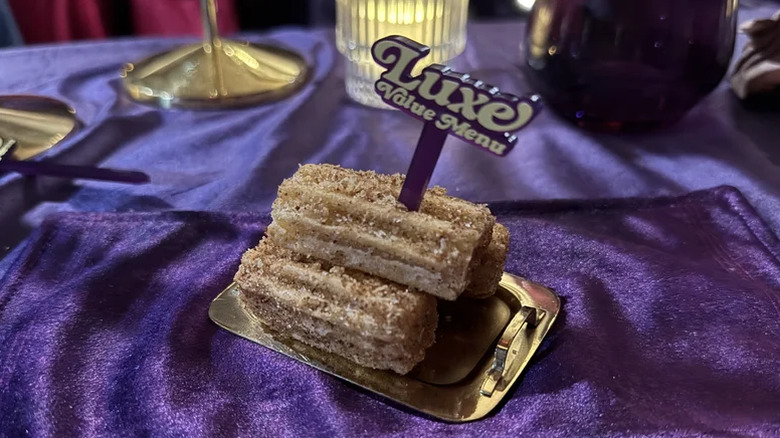 Taco Bell Salted Caramel Churros on a little plate on fancy place setting
