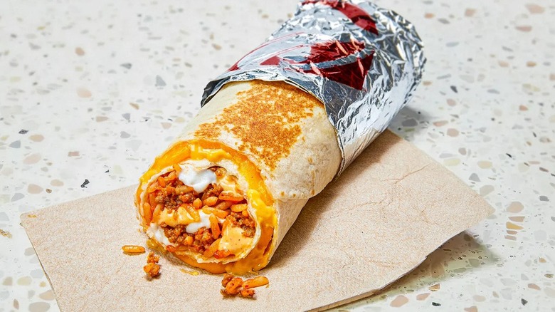 a Taco Bell Quesarito in foil on napkin