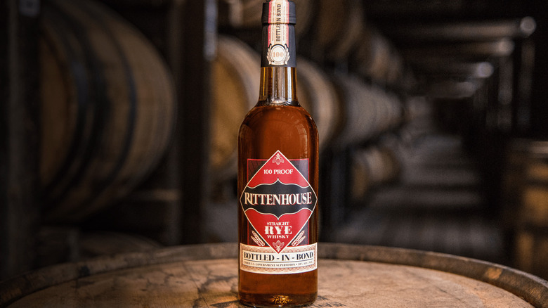 A bottle of Rittenhouse Rye on a barrel
