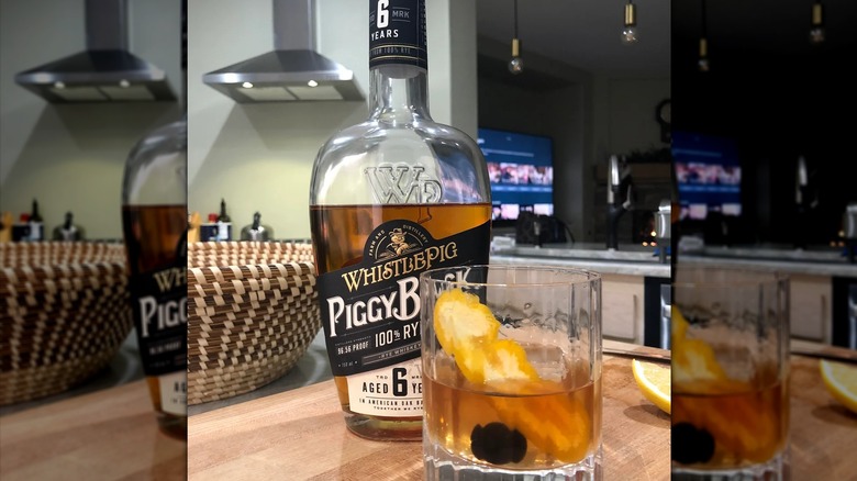 A WhistlePig PiggyBack Rye bottle and an old fashioned cocktail