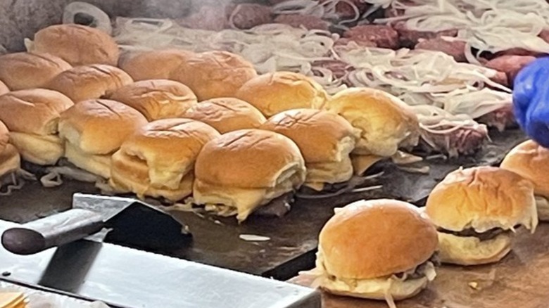 sliders being cooked with onions