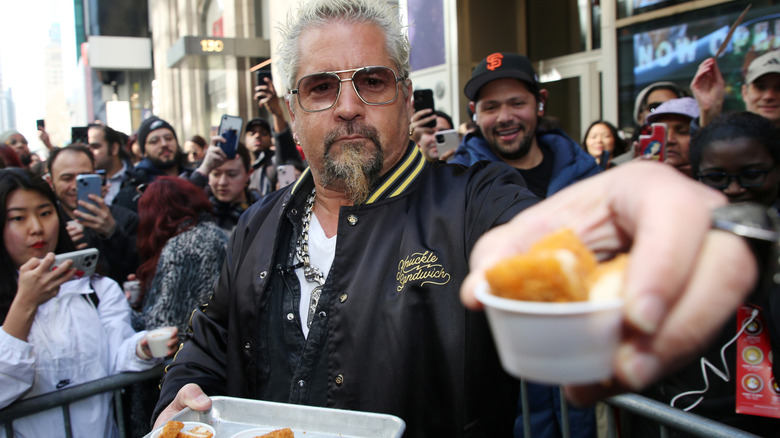 Guy Fieri offering a food sample