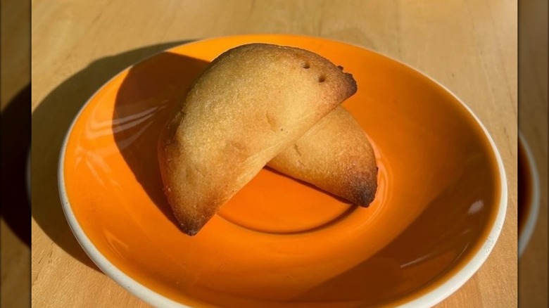 vegan and vegetarian empanadas on a plate on wooden table