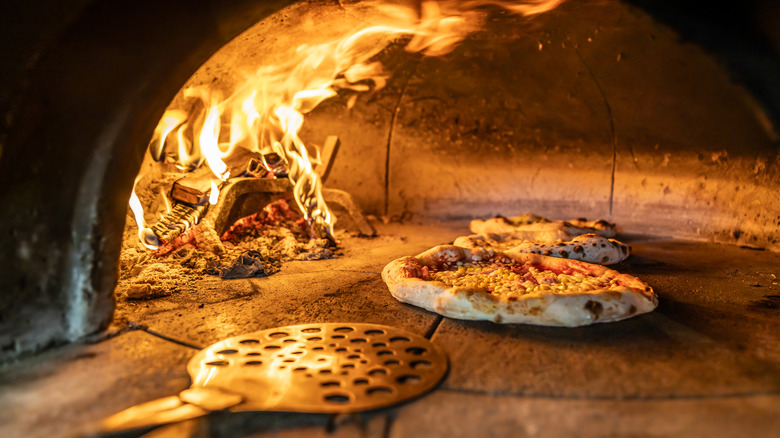 Neapolitan pizza baking in a wood-fired oven