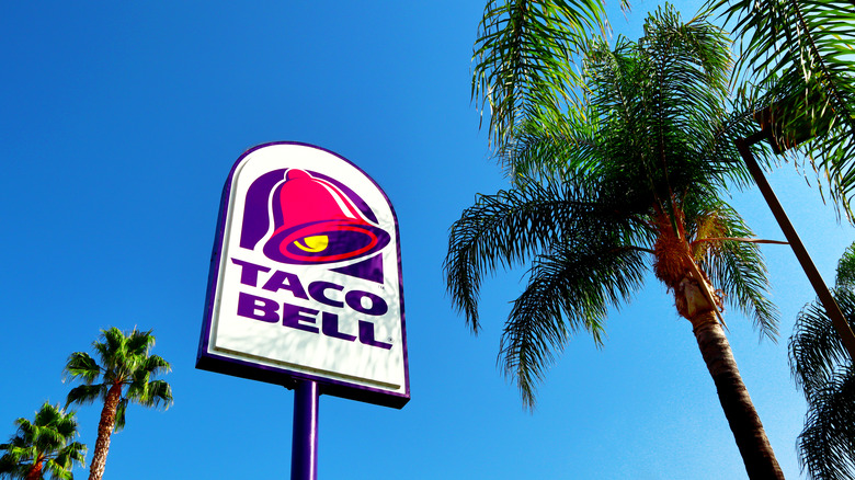 taco bell sign near palm trees