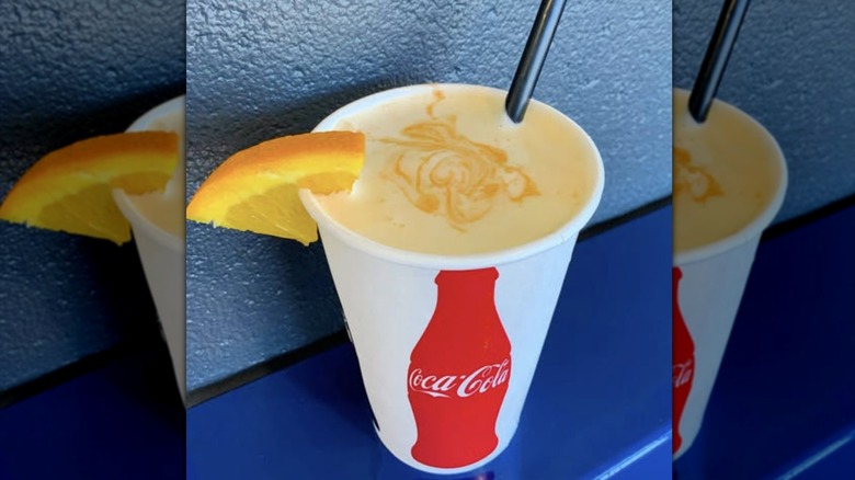 Orange milkshake from Frugals in paper Coca-Cola cup