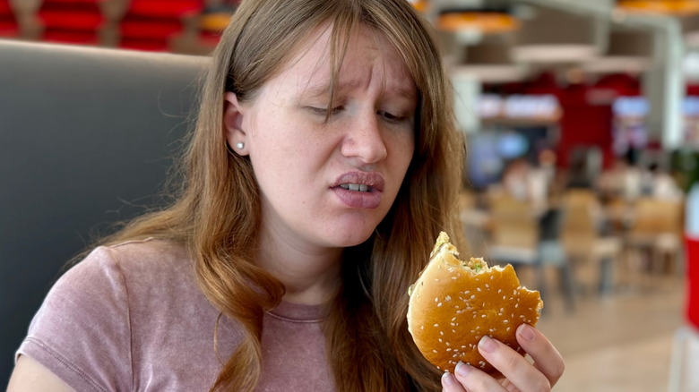 Person displeased with fast food burger