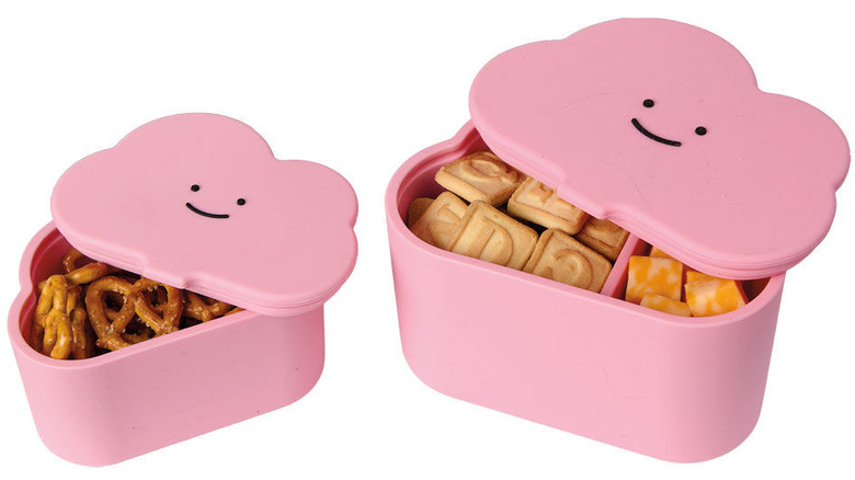 Cloud shaped pink silicone lunch boxes with smiley faces on the lid.