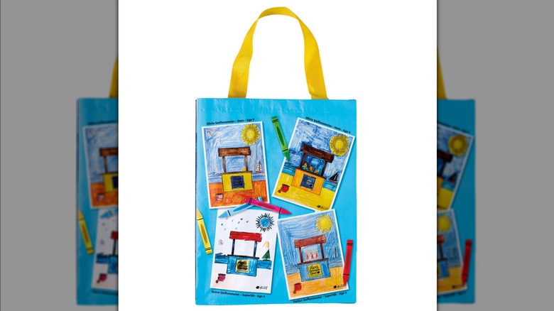Blue and yellow Aldi recycled tote bag featuring kids' pictures of lemonade stand and crayons