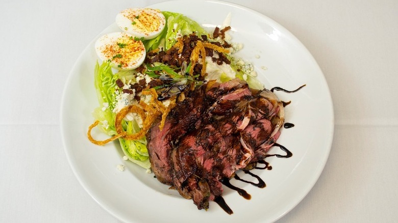 Prime rib served with a wedge salad and hard boiled egg at Clyde's Prime Rib