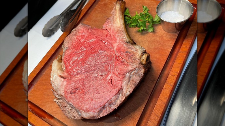 Prime rib on cutting board with side ramekin of salt at Golden Steer Steakhouse