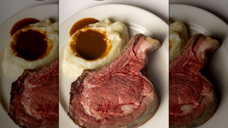 Prime rib served with au jus and mashed potatoes at Lawry's The Prime Rib