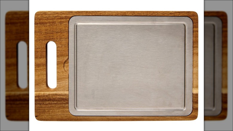 Wood cutting board with titanium insert in the center.