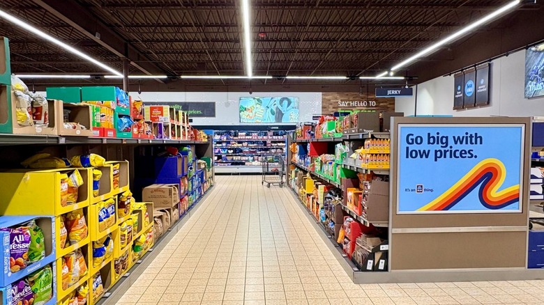 The snack aisle in Aldi with large blue signage on the right side of the aisle.