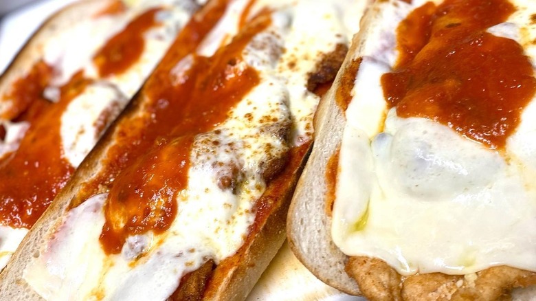 close up of multiple chicken parmesan sandwiches