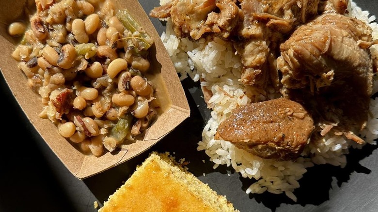 Garlic stuffed pork roast with cornbread and sides