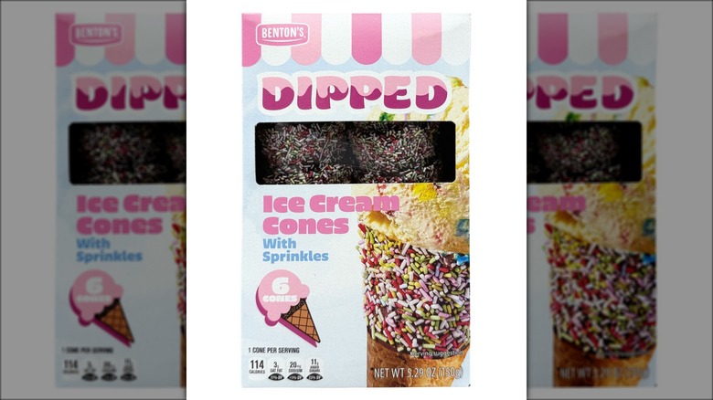 Box of premade dipped ice cream cones with sprinkles against white background.