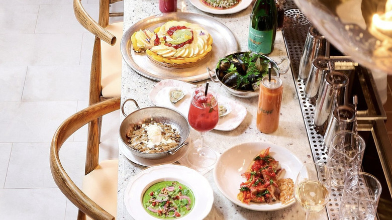 plates of food on bar at Caché, San Francisco