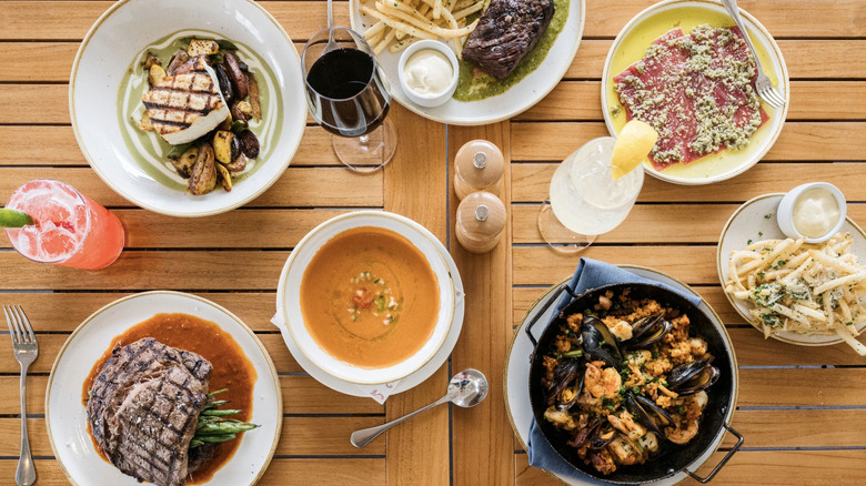 overhead view of a range of dishes from Celeste on wooden table