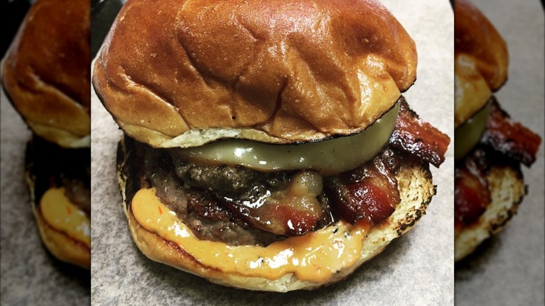 closeup of cheeseburger with bacoon on countertop