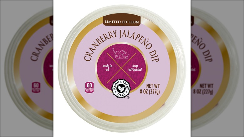 A lid decorated with an image of cranberries and a jalapeño labeled "Cranberry Jalapeño Dip."