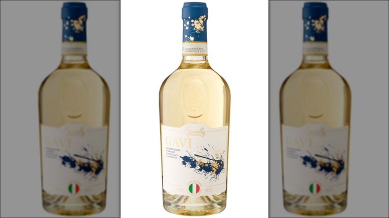 A bottle of white wine labeled Gavi, decorated with paint splatters.