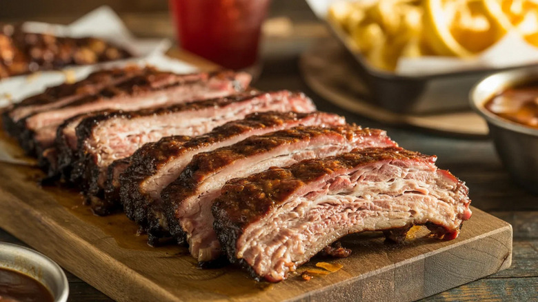 Sliced barbecue ribs on a wooden cutting board