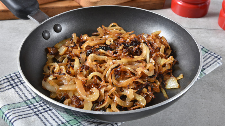 caramelized onions in a pan over a kitchen towel