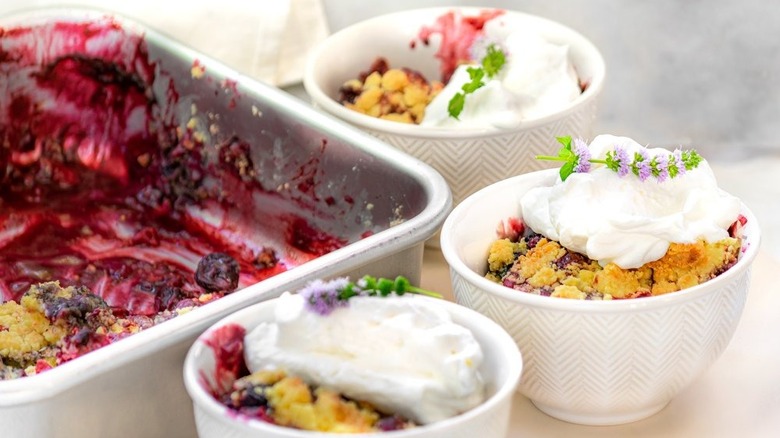 pan and dishes with fruit cobbler