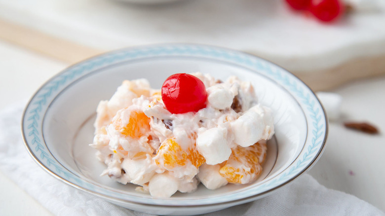 bowl of cherry topped ambrosia salad