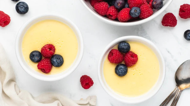 cups of homemade pudding with berries