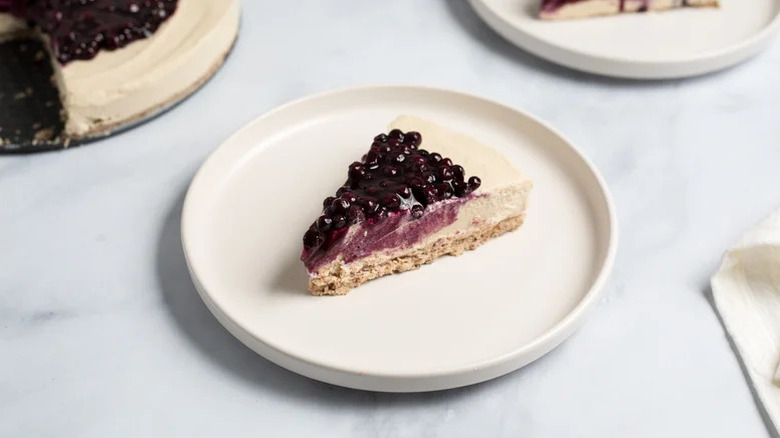 plate with slice of blueberry cheesecake