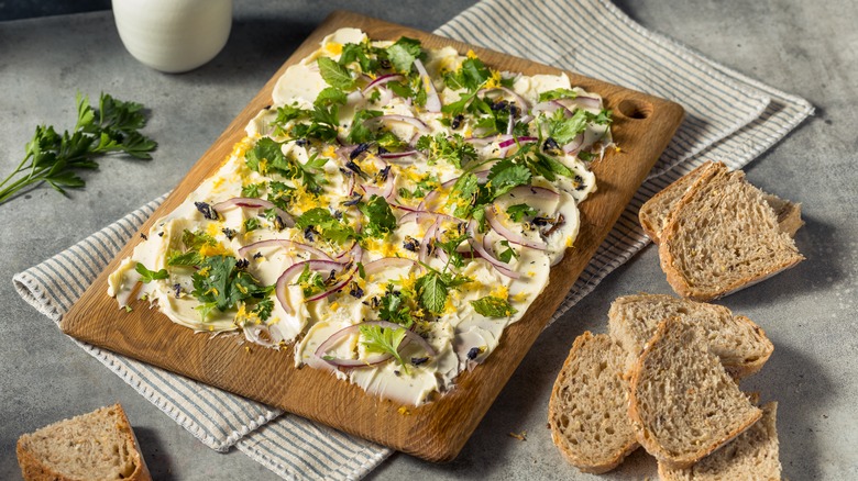 A butter board with herbs