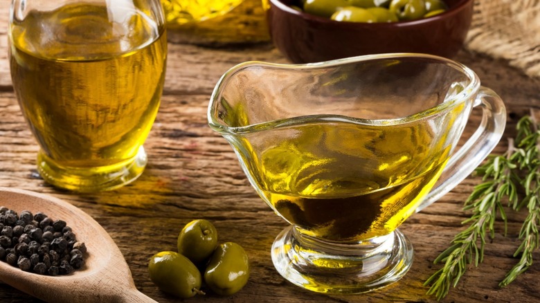Bottle and gravy boat of olive oil