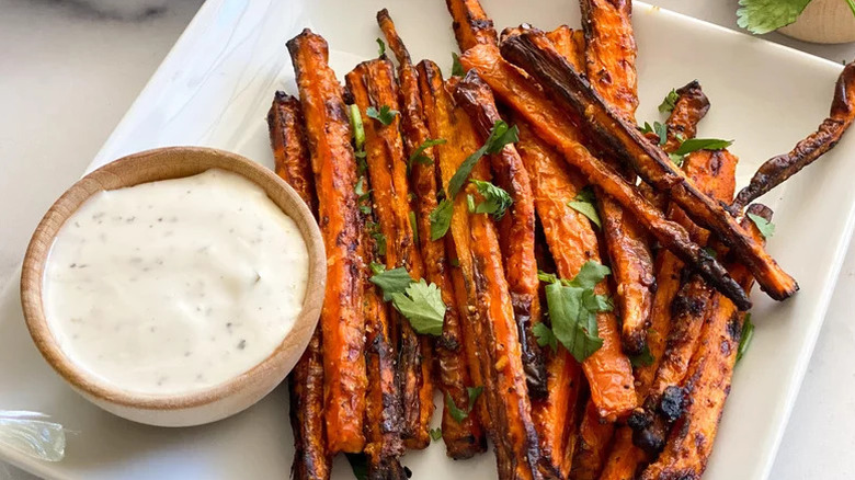 carrot fries on a white plate with dip