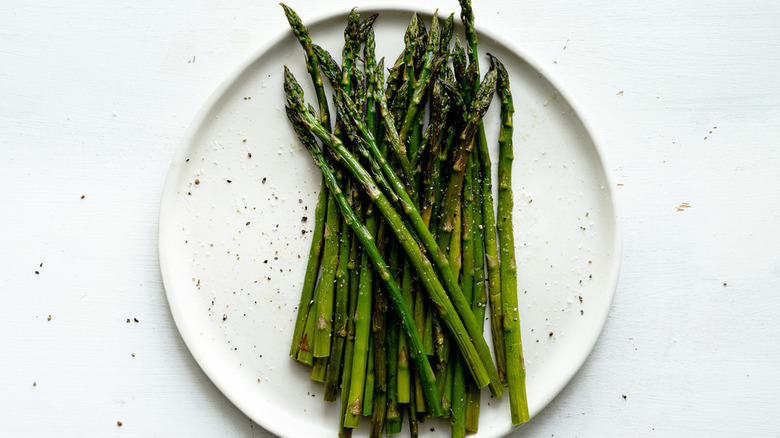 Roasted asparagus on a white plate