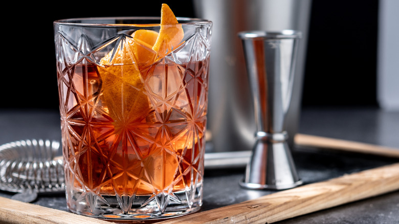 Old fashioned cocktail with orange peel twist