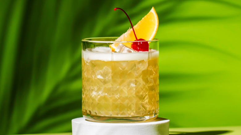 Whisky sour with orange wedge and cherry