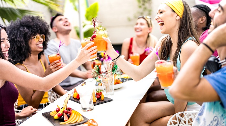 Friends cheersing drinks at party