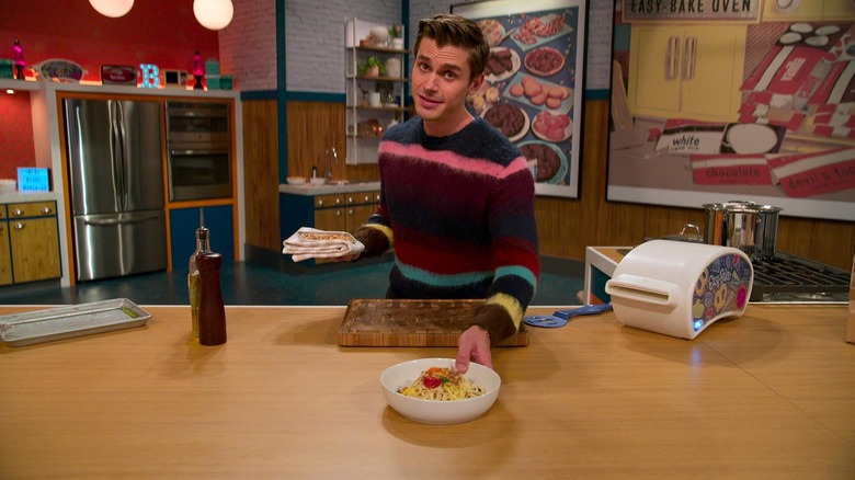 Antoni Porowski talking on the set of Easy-Bake Battle