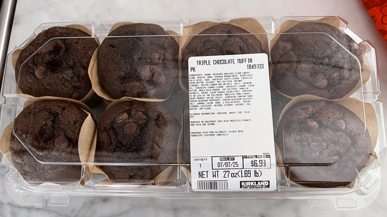 A plastic container of Costco's triple chocolate muffins with ingredient list showing
