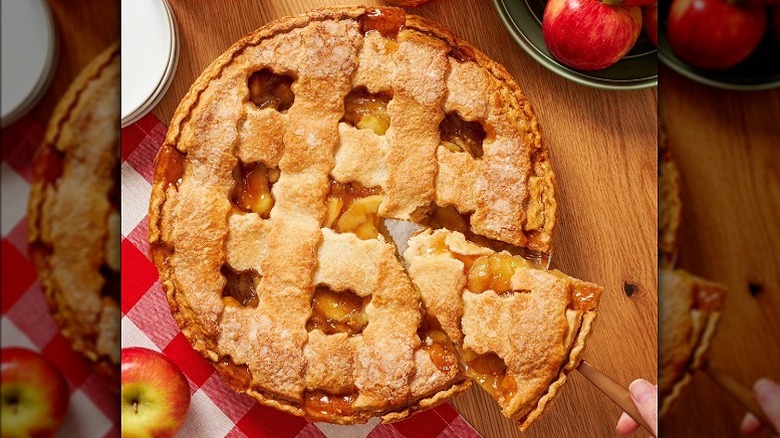Member's Mark honeycrisp apple pie with a lattice crust design with one slice being removed.