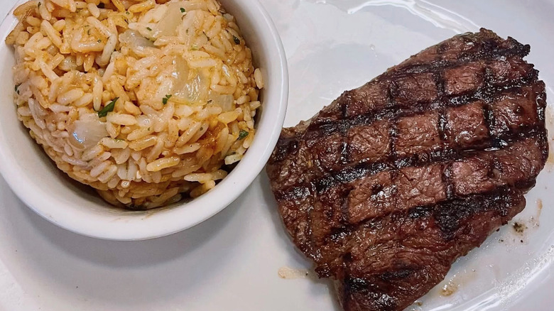 Closeup of grilled steak and side of rice