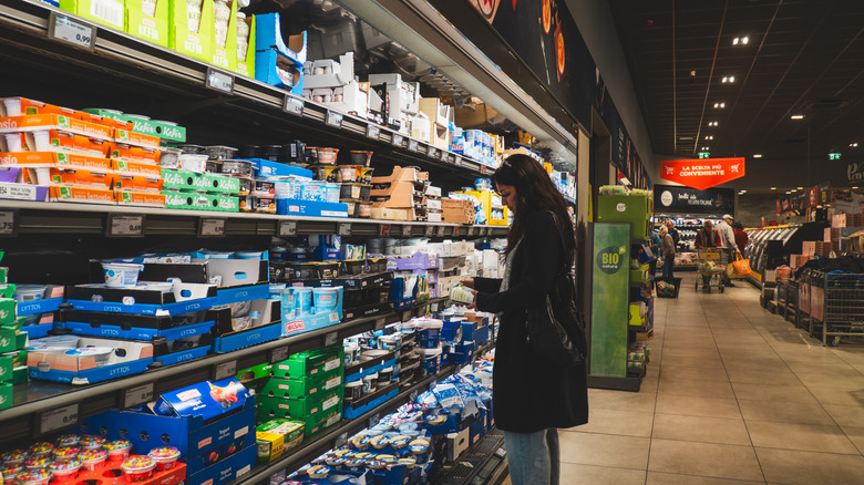Shopper inspecting products at Aldi.