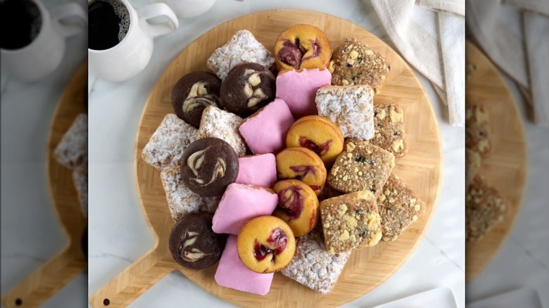 Member's Mark breakfast platter, five flavor assortment, on wood platter with black cup of coffee nearby
