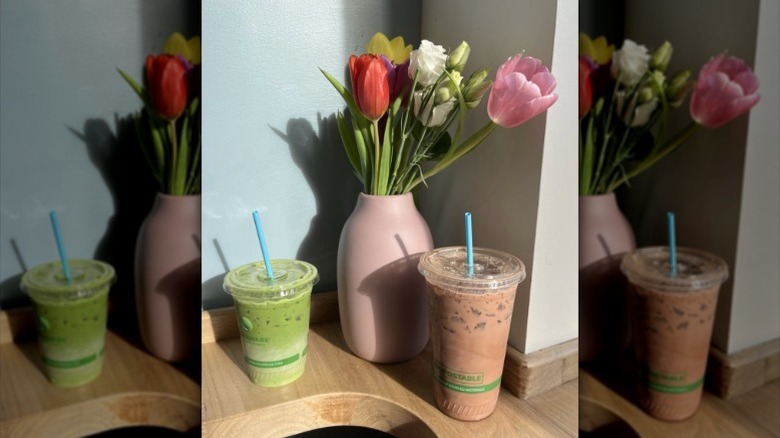 An iced matcha and latte from Clear Flour on a wooden counter