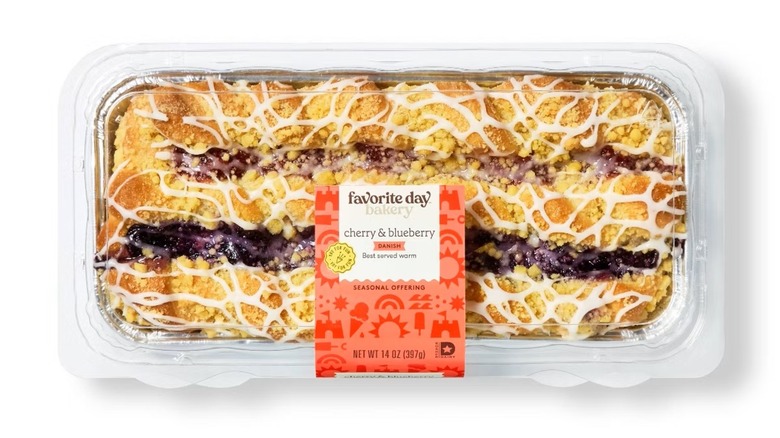 A cherry and blueberry Danish in plastic packaging.