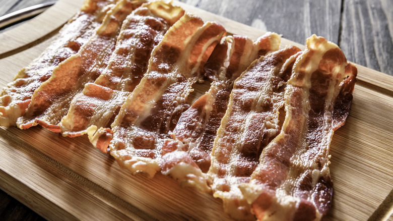 fried bacon on wooden platter