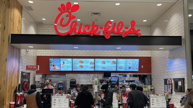 people waiting in line to order at chick-fil-a counter