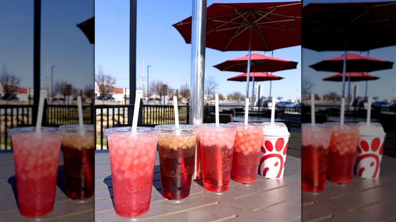 chick-fil-a Strawberry Hibiscus Beverages in takeout cups lined up on patio table at restaurant